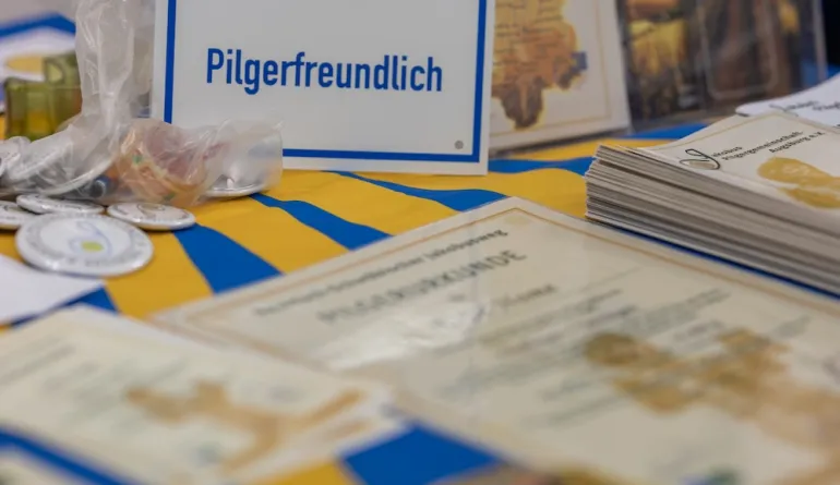 Schild "Pilgerfreundlich" weist den Pilgern den Weg, weitere Materialien liegen am Tisch