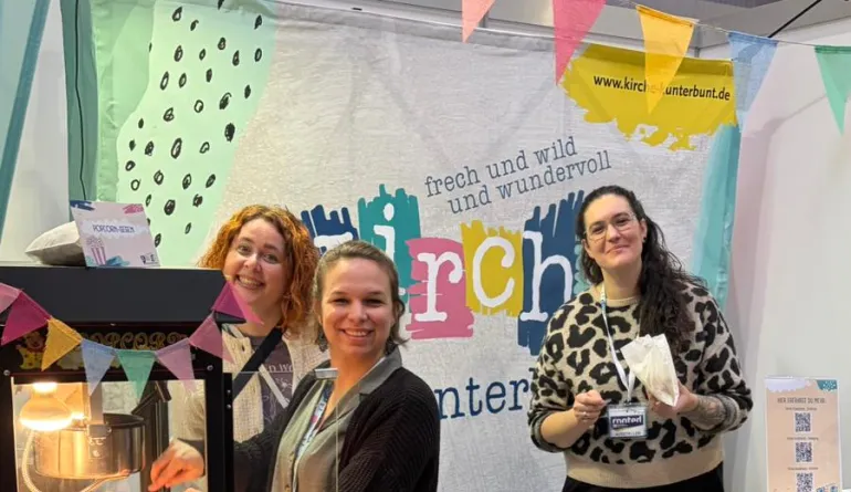 3 Frauen im bunten Messestand